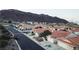 Charming neighborhood streetscape showcasing well-maintained homes with desert landscaping and scenic mountain views at 390 Montego Ln, Boulder City, NV 89005