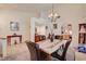 Inviting dining area offering a seamless transition to the living spaces and kitchen with tiled floors at 3987 Saddlewood Ct, Las Vegas, NV 89121