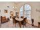 Elegant dining room with high ceilings, large arched window, and views into the kitchen at 3987 Saddlewood Ct, Las Vegas, NV 89121
