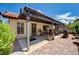 Rear exterior shows a covered patio area with an outdoor grill and brick paved section at 3987 Saddlewood Ct, Las Vegas, NV 89121
