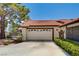 Home exterior featuring a two-car garage, desert landscaping, and a terracotta tile roof at 3987 Saddlewood Ct, Las Vegas, NV 89121