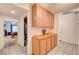 Interior hallway with wooden cabinets and drawers, tile flooring, and doorway leading to a bedroom at 3987 Saddlewood Ct, Las Vegas, NV 89121