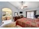 Spacious main bedroom with a walk through into the bathroom, neutral walls, and comfy furnishings at 3987 Saddlewood Ct, Las Vegas, NV 89121