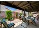 Covered patio area featuring a brick-paved section, outdoor seating, and a grill, perfect for outdoor dining at 3987 Saddlewood Ct, Las Vegas, NV 89121