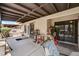 A covered outdoor patio featuring tile flooring, door to the home, and outdoor seating area at 3987 Saddlewood Ct, Las Vegas, NV 89121
