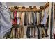 Organized walk-in closet with hanging rods, shelving, and a variety of clothing at 3987 Saddlewood Ct, Las Vegas, NV 89121