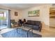 Comfortable living room featuring a sofa, chair, coffee table, and access to the outdoor patio at 4200 S Valley View Blvd # 1077, Las Vegas, NV 89103