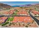 Expansive aerial view showcasing the community's charming red roofs and landscaped grounds, with lake views at 445 Intrepid Ct, Boulder City, NV 89005