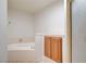 Bathroom featuring a soaking tub with tiled surround and a wooden vanity cabinet at 445 Intrepid Ct, Boulder City, NV 89005