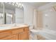 Bathroom featuring a wooden vanity with bright countertop, toilet, and shower-tub combo at 445 Intrepid Ct, Boulder City, NV 89005