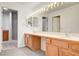 Bright bathroom with dual sinks, large mirror, vanity, and access to a separate shower room at 445 Intrepid Ct, Boulder City, NV 89005