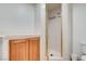 Bright bathroom featuring a glass-enclosed shower with built-in shelving, and a wooden vanity cabinet at 445 Intrepid Ct, Boulder City, NV 89005