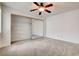 Bedroom with carpeted floors, ceiling fan, and closet with mirrored sliding doors at 445 Intrepid Ct, Boulder City, NV 89005