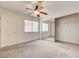 Bright bedroom with carpet, ceiling fan, and closet with mirrored sliding doors at 445 Intrepid Ct, Boulder City, NV 89005