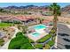 Overhead view of a community pool and hot tub with palm trees and desert landscaping at 445 Intrepid Ct, Boulder City, NV 89005