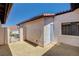 View of the stucco exterior, light-blue door, and window, along with a gravel-covered area at 445 Intrepid Ct, Boulder City, NV 89005