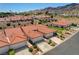Charming single-story home with a red tile roof, manicured landscaping, and an attached two-car garage at 445 Intrepid Ct, Boulder City, NV 89005