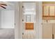 Hallway view of the bathroom, with a wooden vanity, and the laundry area with white washer and dryer at 445 Intrepid Ct, Boulder City, NV 89005