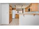 Kitchen featuring tile floors, wood cabinets, modern appliances, and plenty of storage at 445 Intrepid Ct, Boulder City, NV 89005