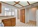 Well-lit kitchen with oak cabinets, tiled countertops, pantry, and tiled floors, enhanced by a distinctive boxed ceiling light at 445 Intrepid Ct, Boulder City, NV 89005