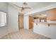 Open kitchen with a ceiling fan, wood cabinets, tile floors, and lots of natural light at 445 Intrepid Ct, Boulder City, NV 89005