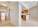 View of the kitchen area with tile floors, light wood cabinets, and updated appliances at 445 Intrepid Ct, Boulder City, NV 89005