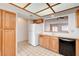 Bright kitchen showcasing oak cabinets, white appliances, tiled counters, and an open layout at 445 Intrepid Ct, Boulder City, NV 89005