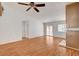 Comfortable living room features wood-look flooring, a ceiling fan, and sliding door access to outdoor space at 445 Intrepid Ct, Boulder City, NV 89005