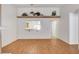 Bright living room features wood-look flooring, a ceiling fan, and a pass-through window to the kitchen at 445 Intrepid Ct, Boulder City, NV 89005