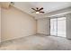 Spacious main bedroom with carpet, fan, and sliding glass door to a private patio at 445 Intrepid Ct, Boulder City, NV 89005