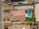 Aerial view of the home highlights the sparkling pool, lush landscaping, and private backyard at 4620 E Suntree Ct, Pahrump, NV 89061