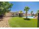 A lush green backyard features turf, palm trees, and is perfect for outdoor activities at 4620 E Suntree Ct, Pahrump, NV 89061