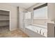Bathroom featuring bathtub, glass shower, and window at 4620 E Suntree Ct, Pahrump, NV 89061