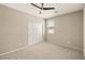 This bedroom has neutral-colored walls, a ceiling fan, and a window for natural light at 4620 E Suntree Ct, Pahrump, NV 89061