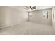 Large bedroom featuring neutral paint and carpet, ceiling fan, and three windows at 4620 E Suntree Ct, Pahrump, NV 89061
