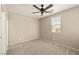 This bedroom has neutral-colored walls, a ceiling fan, and a window for natural light at 4620 E Suntree Ct, Pahrump, NV 89061