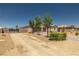 Long driveway leading to a charming single-story home with a two-car garage and desert landscaping at 4620 E Suntree Ct, Pahrump, NV 89061