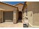 Close up view of the entry to a charming single-story home with a two-car garage and neat landscaping at 4620 E Suntree Ct, Pahrump, NV 89061