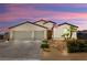 Charming single-story home featuring a tile roof, two-car garage, and well-manicured front yard at 4620 E Suntree Ct, Pahrump, NV 89061