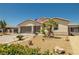 Attractive single-story home featuring a two-car garage, low-water landscaping, and an American flag at 4620 E Suntree Ct, Pahrump, NV 89061
