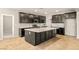 Modern kitchen with an oversized island, dark cabinets, and tile floors at 4620 E Suntree Ct, Pahrump, NV 89061