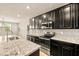 Spacious kitchen with granite countertops, stainless appliances, and dark cabinets at 4620 E Suntree Ct, Pahrump, NV 89061