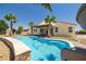 Backyard pool view of private oasis featuring a slide, covered patio, and well-maintained lawn at 4620 E Suntree Ct, Pahrump, NV 89061
