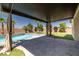 Relaxing backyard oasis, covered patio, pavers, stunning pool and landscaped yard at 4620 E Suntree Ct, Pahrump, NV 89061