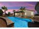 Inviting backyard showcasing a sparkling blue pool and a covered patio, perfect for outdoor relaxation at 4620 E Suntree Ct, Pahrump, NV 89061