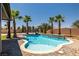 Beautiful backyard pool with lush landscaping and water feature creates a serene oasis at 4620 E Suntree Ct, Pahrump, NV 89061