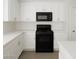 Well-lit kitchen featuring white cabinets, countertops, and modern black appliances at 520 Shire Hall St, Las Vegas, NV 89178