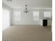 Bright and airy living room area with neutral walls, carpet, and a chandelier at 520 Shire Hall St, Las Vegas, NV 89178