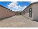 Large backyard with gravel area, brick wall and view of surrounding homes at 5264 Mystic Ivy Dr, Las Vegas, NV 89149