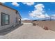 Spacious backyard with stone surface and block wall fence offers privacy for outdoor entertaining at 5264 Mystic Ivy Dr, Las Vegas, NV 89149